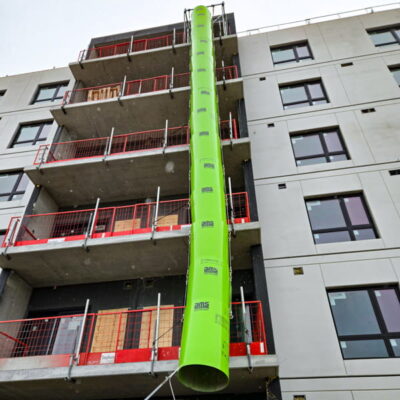 Green Superchute installed on a building.